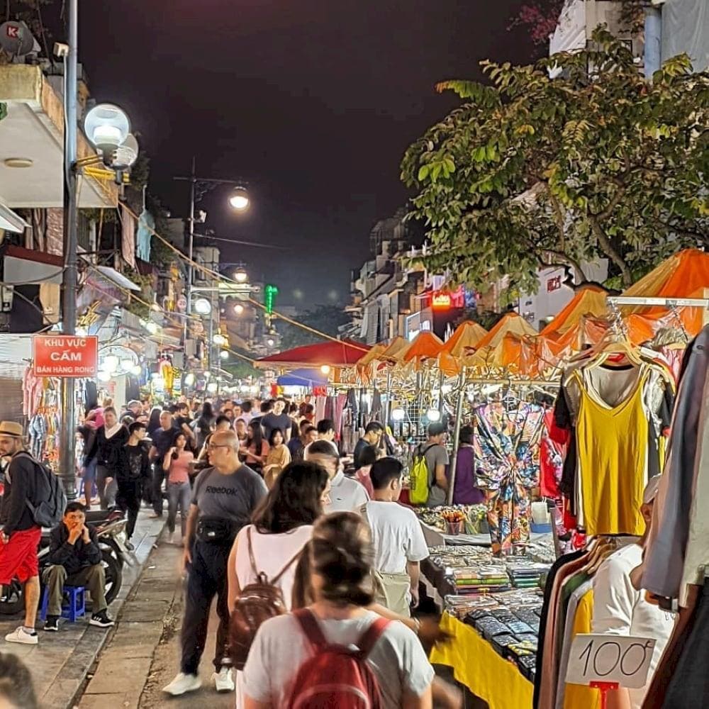 Visitors strolling through Hanoi&rsquo;s vibrant streets at night